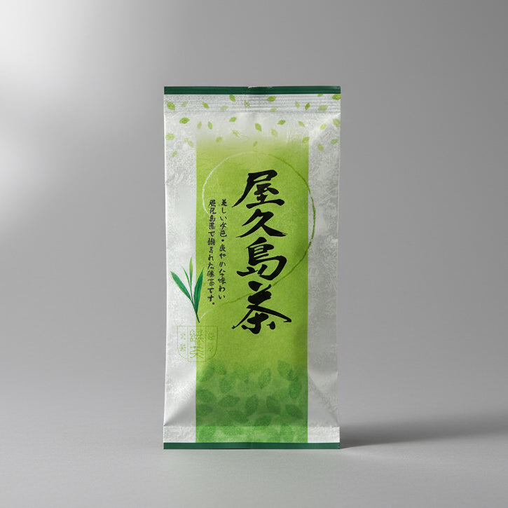 A packaged bag of #0133.K2 Yamane-en: First Flush Saemidori Fukamushicha from Yakushima Island, displayed on a wooden surface.